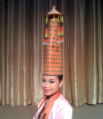 A conical cap worked in red, white, black and yellow beads.